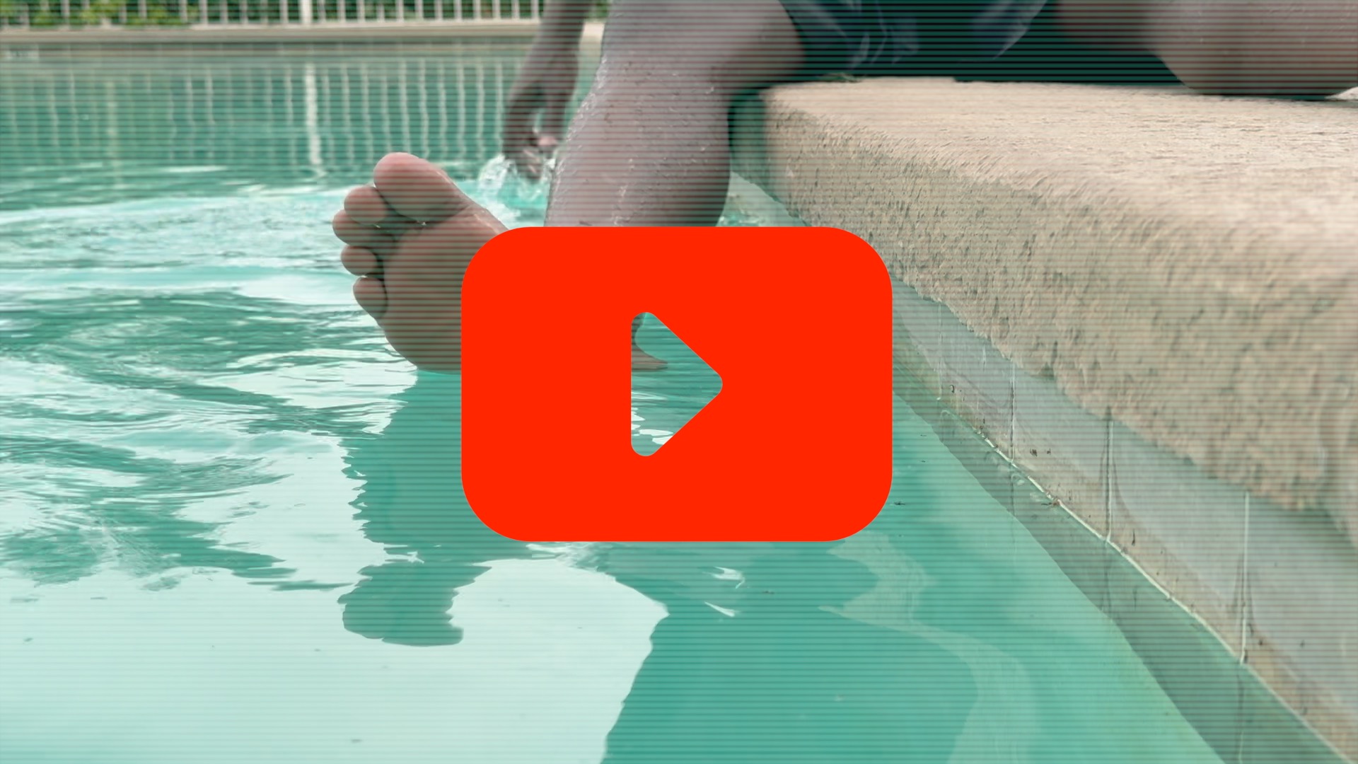 Feet in pool water with play button overlay