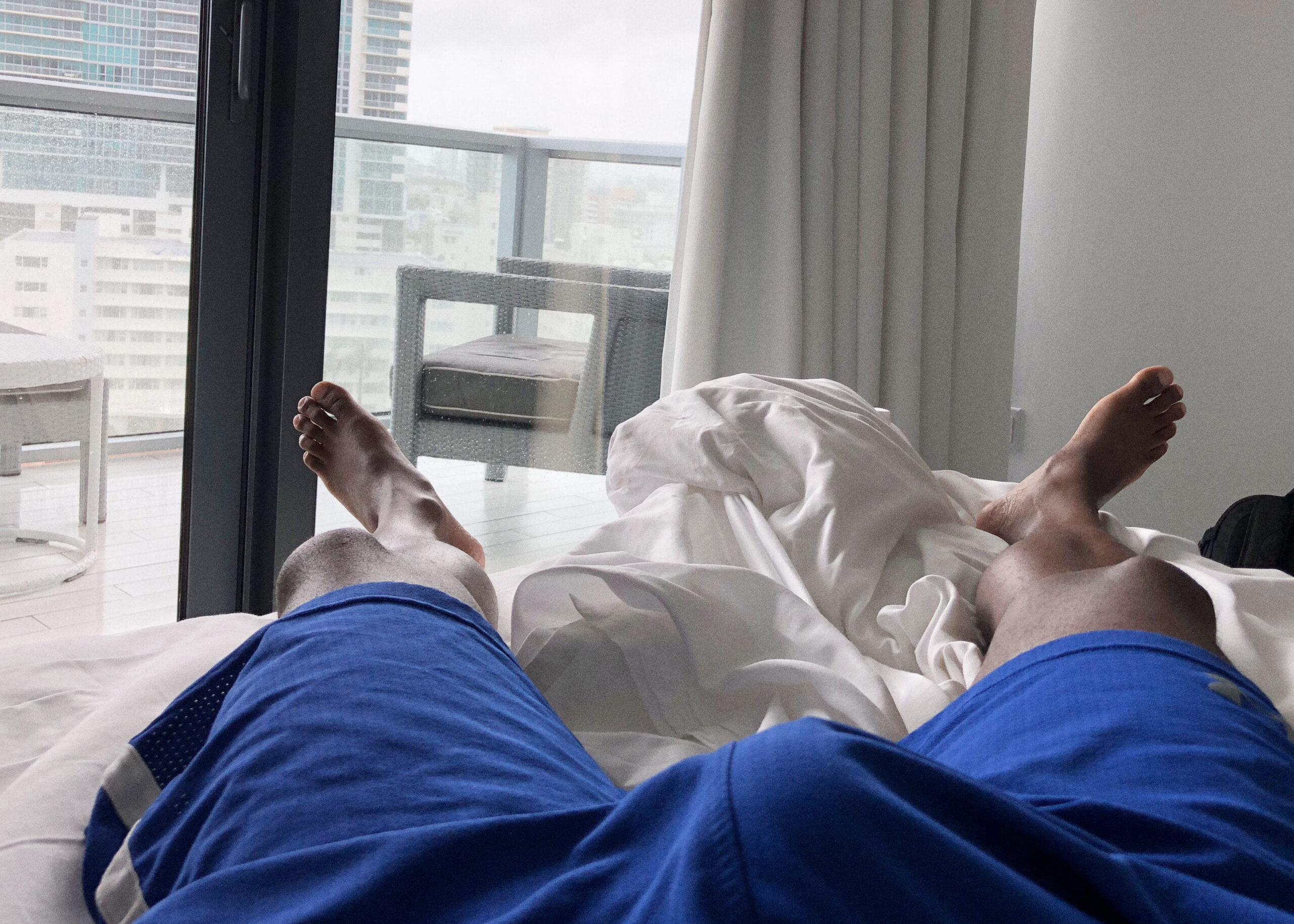 Blue shorts bulge feet city view